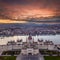 Budapest, Hungary - Aerial drone view of the beautiful Parliament of Hungary with a dramatic colorful sunset and sightseeing boats