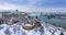 Budapest, Hungary - Aerial panoramic view of the snowy Buda Castle Royal Palace from above with the Szechenyi Chain Bridge