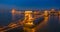 Budapest, Hungary - Aerial panormaic view of the famous illuminated Szechenyi Chain Bridge at blue hour with Parliament building