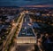 Budapest, Hungary - Aerial view of the iIlluminated Museum of Ethnography at City Park with Heroes` Square and skyline of Budapest