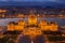 Budapest, Hungary - Aerial view of the illuminated Hungarian Parliament building at golden hour with Christmas tree