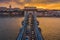 Budapest, Hungary - Aerial view of Szechenyi Chain Bridge with afternoon traffic, beautiful golden sunset sky