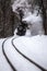 Budapest, Hungary - Beautiful snowy winter forest scene with old steam locomotive on the track in the Hungarian woods