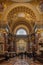 Budapest, Hungary - Feb 8, 2020: Tourist admire gilded cupola dome of St. Stephen Basilica