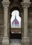 Budapest, Hungary - The Hungarian Parliament building through a medieval balcony with arch