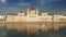 Budapest, Hungary - Hungarian Parliament building with warm sunset lights and reflections on River Danube