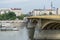 Budapest / Hungary - July 28 2019: Bridge in Budapest, with group of people crossing and boat in the river