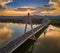 Budapest, Hungary - Megyeri Bridge at sunset with speedboat on River Danube and heavy traffic