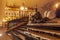 Budapest, Hungary night view of famous poet Attila Jozsef bronze statue before the illuminated Gothic style