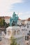 Budapest, Hungary - Nov 6, 2019: St. Stephen equestrian statue from behind. Tourists sightseeing on the square by the Fishermans