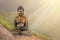 Buddah sculpture in a green mountains with sunlight.Space for text
