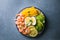 Buddha bowl with avocado, prawns, rice, on light background. Healthy food, clean eating, Buddha bowl, top view