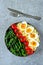 Buddha bowl with bulgur, green beans, cherry tomatoes and boiled egg halves.