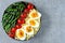 Buddha bowl with bulgur, green beans, cherry tomatoes and boiled egg halves.