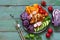 Buddha bowl, chicken breast baked with spices, fresh vegetables, blue rustic background. Top view, copy space.