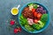 Buddha bowl meal with kale, spinach and chard leaves, brown rice, tomato, broccoli, radish, fresh green sprouts and pine nuts. Hea