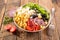 Buddha bowl with pasta, feta cheese, tomato