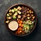 Buddha bowl with quinoa, tofu, avocado, sweet potato, brussels sprouts and tahini dressing, top view