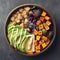 Buddha bowl with quinoa, tofu, avocado, sweet potato, brussels sprouts and tahini dressing, top view