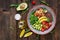 Buddha bowl with shrimps, tomato, avocado, quinoa, lemon and arugula