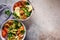 Buddha bowls salad with avocado, sweet potato, falafel, zucchini, tomatoes and broccoli, top view