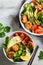 Buddha bowls salad with avocado, sweet potato, falafel, zucchini, tomatoes and broccoli, top view