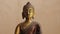 Buddha bronze idol face illuminated by daylight