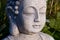 Buddha face on sunny meadow.
