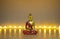 Buddha figure in meditation with candle lights