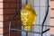 Buddha head made from transparent yellow glass on the shelf, decoration element in oriental style. Exterior, outdoor garden decor