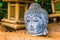 Buddha head sculpture in closeup, traditional spiritual decoration