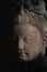 Buddha head statue in shadow