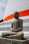 Buddha Meditating at Stupa with Red Ribbon