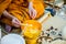 Buddha monk hold candlestick above holy water bowl. religion ceremony. Buddhist holy water. image for copy space.