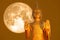 Buddha pacifying the ocean and full moon on orange sky in the Asanha bucha day