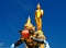 Buddha and Phra Rahu soaring into blue sky