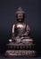 Buddha`s figure, made of metal in a meditation pose