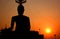 The Buddha\'s Silhouette cutting the sunset.