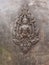 Buddha sculpture image on old bronze surface.