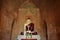 Buddha sculpture inside old pagoda with ancient paintings on the