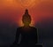 Buddha silhouette with mandala on sunset blurred background