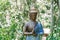 Buddha statue on the background of the green jungle of Bali. Cafe in the jungle. Tropical trees, palm trees , and bamboo thickets