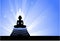 Buddha statue on blue glowing background