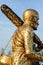 Buddha statue with enormous gold leafs.