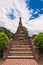 Buddha statue in front of pagoda in sukhothai