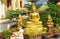 Buddha statue and laughing little monks near Buddhist temple