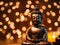 buddha statue on a wooden table in a dark background