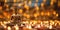 Buddha statues and candles on Vesak Day, bokeh blur background. Generative AI