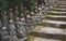 Buddha statues with knitted colorful hat offerings along stairs at the temple Diasho-in in Miyajima, Hiroshima, Japan