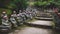 Buddha statues with knitted hat offerings along shrine path at the temple Diasho-in in Miyajima, Hiroshima, Japan